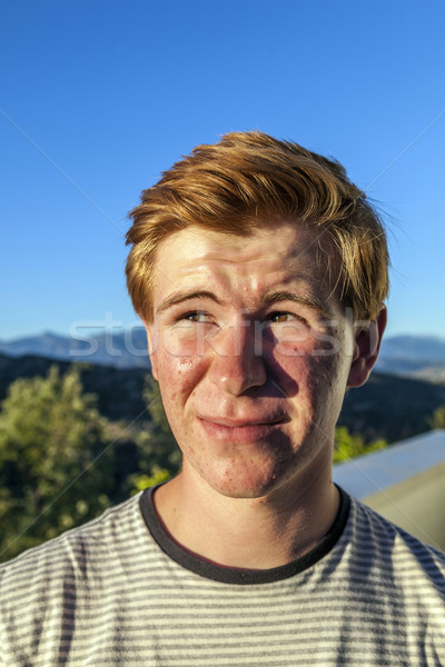 portrait of handsome boy with red hair under blue sky Stock photo © meinzahn