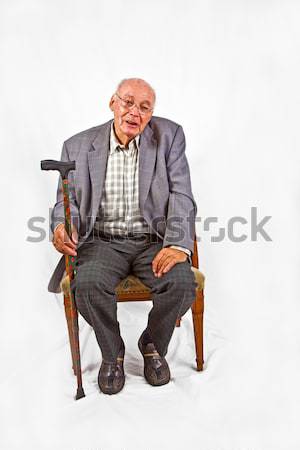 friendly senior man sitting in his armchair Stock photo © meinzahn