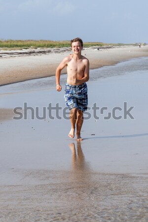 young boy in the sea in cold water but showing all right, thumps Stock photo © meinzahn