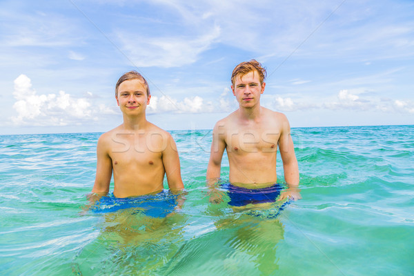 brothers enjoy swimminmg in the ocean  Stock photo © meinzahn