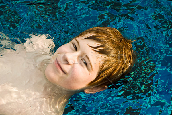 boy with red hair in pool Stock photo © meinzahn