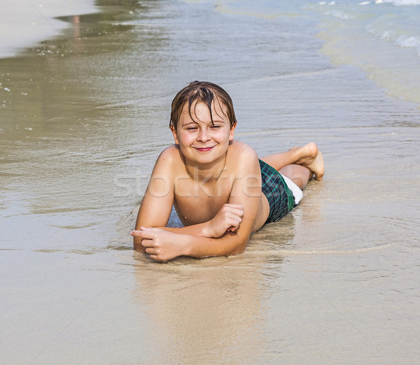 happy boy is lying at the beach Stock photo © meinzahn