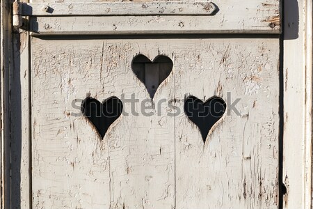 old wooden door with a carved romantic heart Stock photo © meinzahn