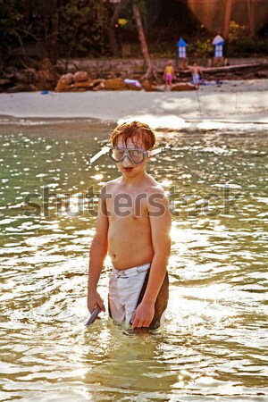 young boy wearing a diving mask is walking at the beautiful beac Stock photo © meinzahn