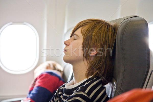 boy sleeping in the aircraft Stock photo © meinzahn