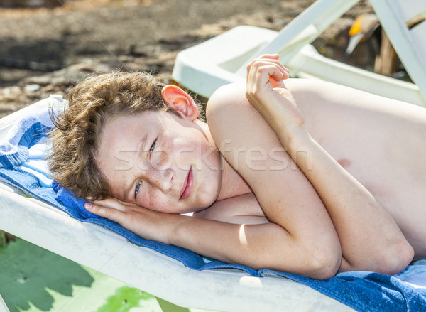 relaxed boy enjoys lying on the couch Stock photo © meinzahn