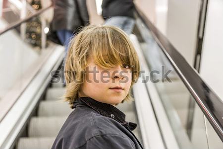child is smiling self confident on a stairway in a shopping mall Stock photo © meinzahn