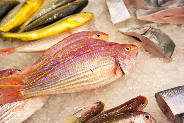 whole fresh fishes are offered in the fish market in asia Stock photo © meinzahn