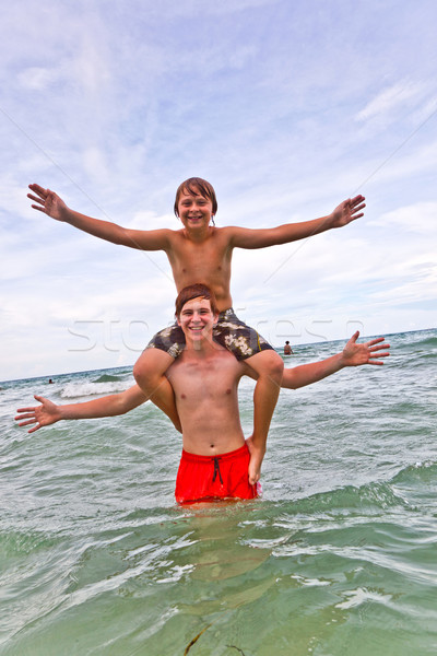 brothers have fun in the beautiful clear sea Stock photo © meinzahn