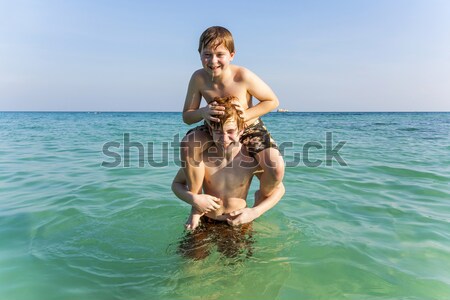 brothers are playing together in a beautiful sea with crystal cl Stock photo © meinzahn