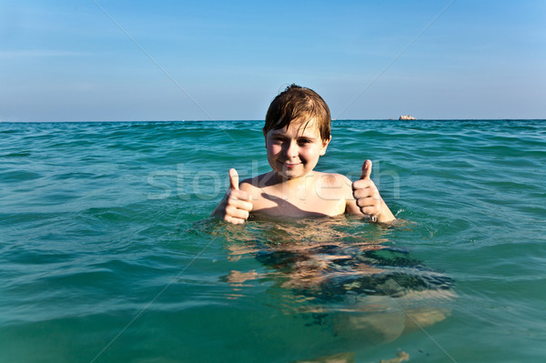 boy with red hair is enjoying the clear warm water at the beauti Stock photo © meinzahn