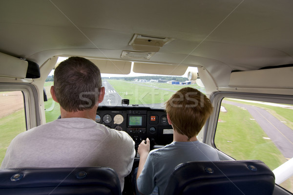 joung boy is flying aircraft assisted by a trainer Stock photo © meinzahn