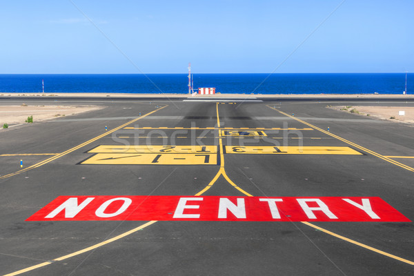 no entry sign at the runway of the airport with ocean in backgro Stock photo © meinzahn