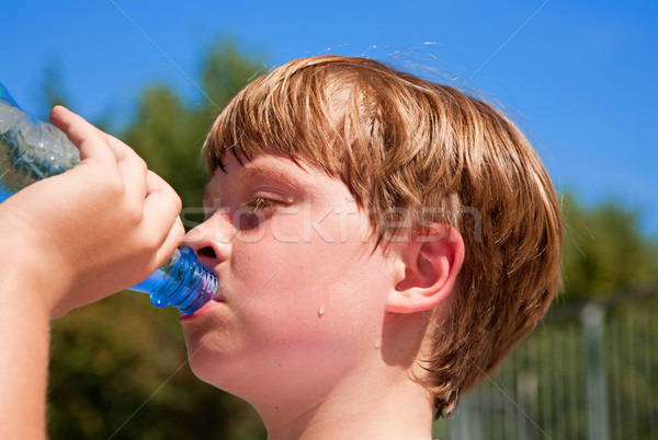 young boy drinks water out of a bottle after sports  Stock photo © meinzahn