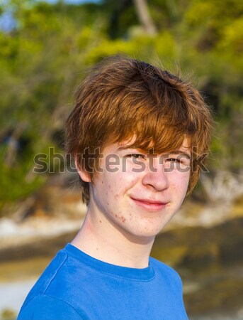young confident boy with red hair smiles happy Stock photo © meinzahn