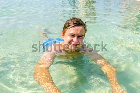 Jóképű tini jókedv úszik óceán tengerpart Stock fotó © meinzahn