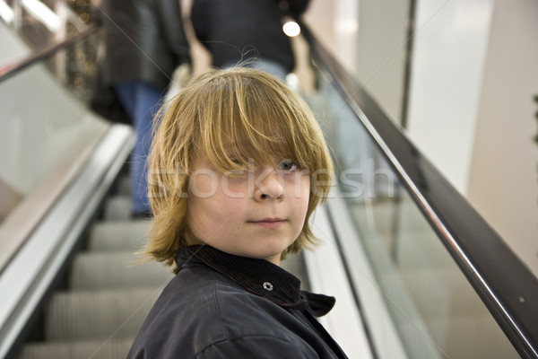 child is smiling self confident on a stairway in a shopping mall Stock photo © meinzahn