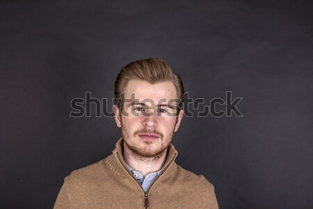 cool boy with blue shirt posing in studio Stock photo © meinzahn