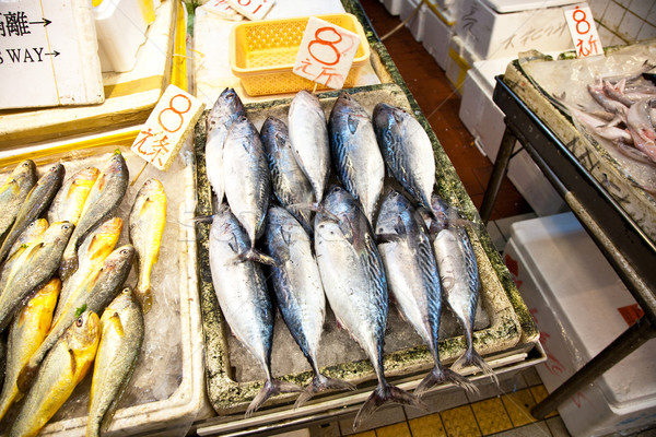 whole fresh fishes are offered in the fish market in asia Stock photo © meinzahn