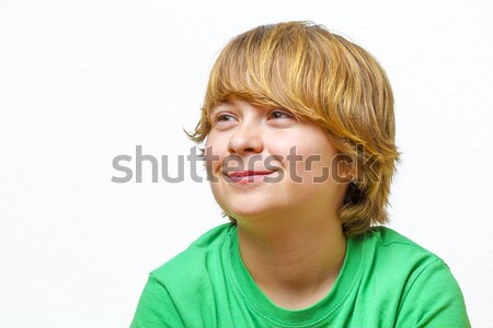 Stock photo: smiling boy sitting on a sofa