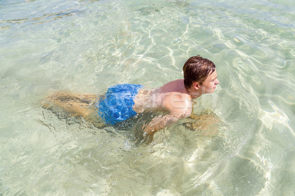 handsome teen has fun swimming in the ocean Stock photo © meinzahn