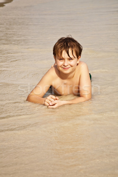 happy boy lying at the beach Stock photo © meinzahn