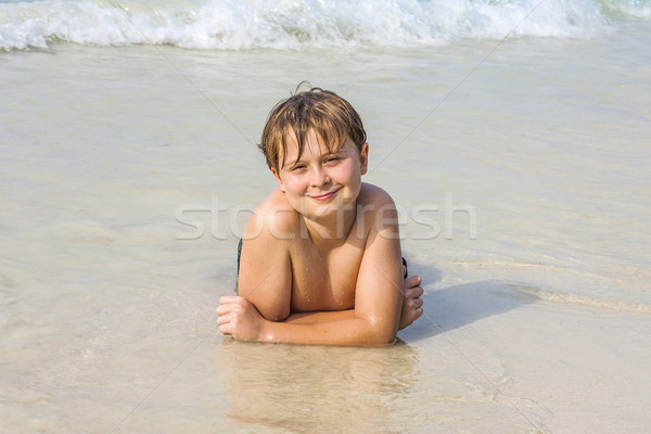 boy at the beach enjoys the sandy beach Stock photo © meinzahn