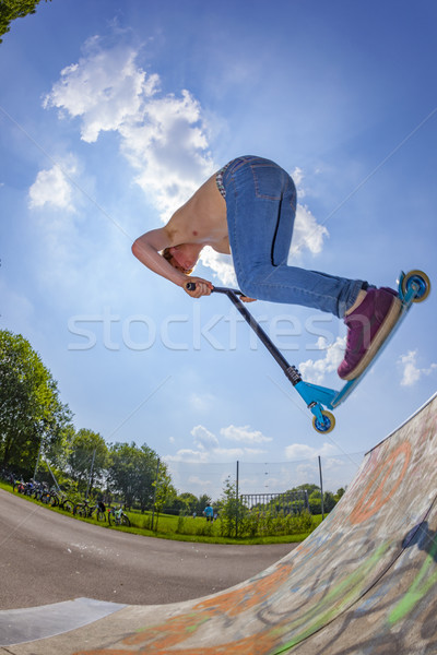 boy going airborne with a scooter Stock photo © meinzahn