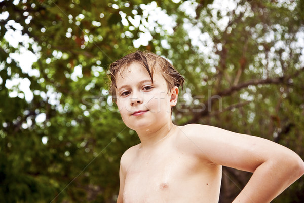 young boy with wet hair comes out of the sea   smiling and looks Stock photo © meinzahn