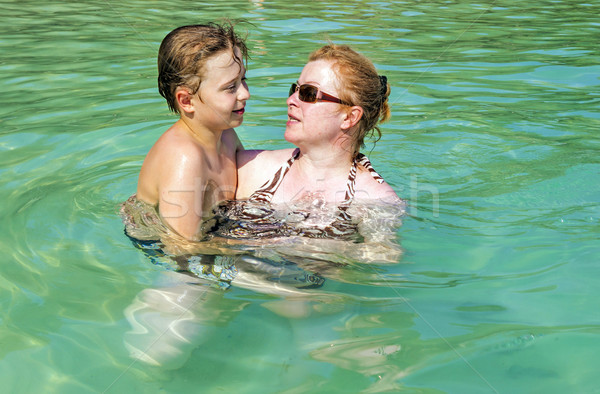 mother and son hugging in the ocean  Stock photo © meinzahn