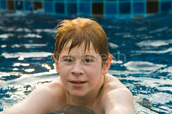 boy with red hair in pool Stock photo © meinzahn