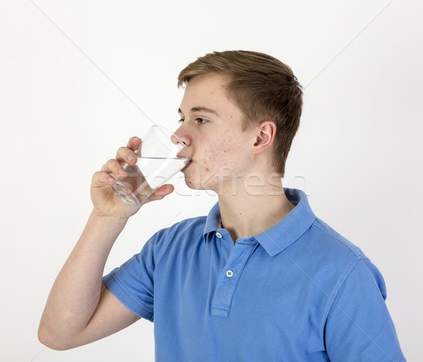 portrait of attractive caucasian teenage boy drinking water  Stock photo © meinzahn