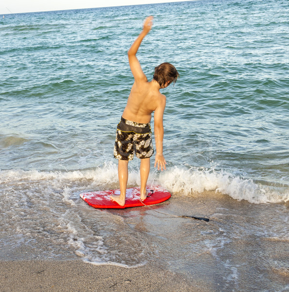 boy learns surfing at the beach  Stock photo © meinzahn