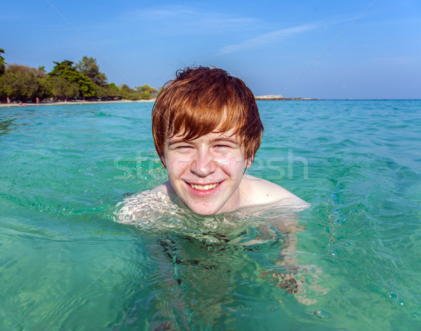 Piros fiú kristály víz tenger tengerpart Stock fotó © meinzahn