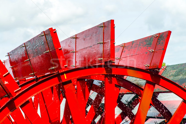Stock photo: Red Riverboat Paddle Wheel in a River with Trees