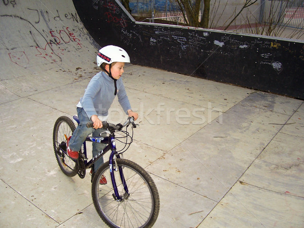 joung boy with his mountainbike trains BMX tricks in the halfpip Stock photo © meinzahn