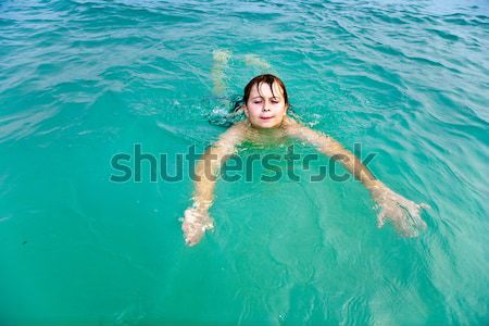 child swims in the pool and has fun  Stock photo © meinzahn