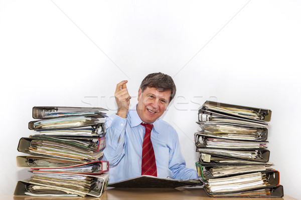 man studies folder with files at his desk in the office Stock photo © meinzahn