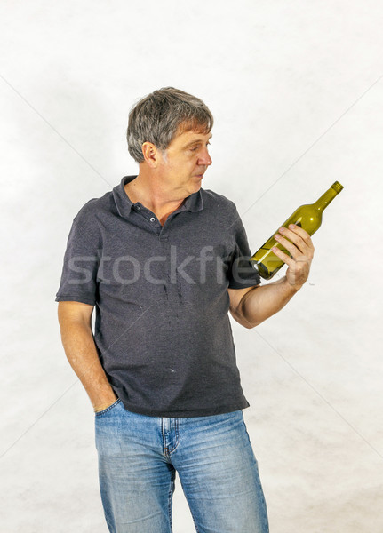 man drinks alcohol out of a bottle Stock photo © meinzahn