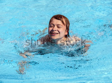 boy rests on his ellbow at the edge of the pool  Stock photo © meinzahn