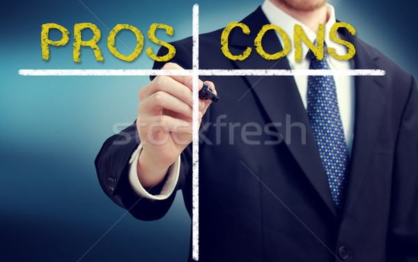 Business man writing pros and cons Stock photo © Melpomene