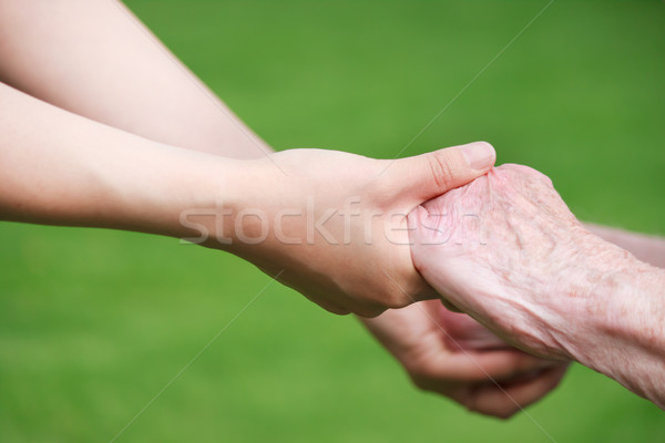 Idős fiatal nők kéz a kézben kívül kezek szeretet Stock fotó © Melpomene