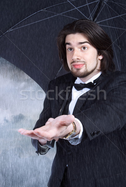 Man Under Umbrella Checking for Rain Coming or Clearing Stock photo © Melpomene