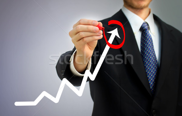 Businessman circling a rising arrow Stock photo © Melpomene