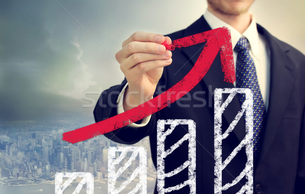Businessman with Graph Representing Growth Stock photo © Melpomene