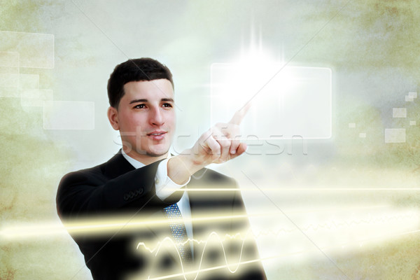 Young business man selecting a touch screen button  Stock photo © Melpomene