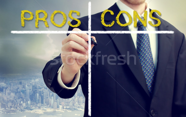 Business man writing pros and cons Stock photo © Melpomene