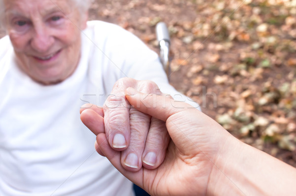 Idős fiatal nő kéz a kézben ősz levelek kezek Stock fotó © Melpomene