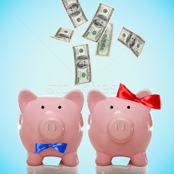 Hundred Dollar bills falling in or flying out of a piggy bank couple Stock photo © Melpomene