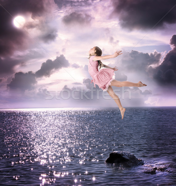 Little girl jumping into the night sky Stock photo © Melpomene